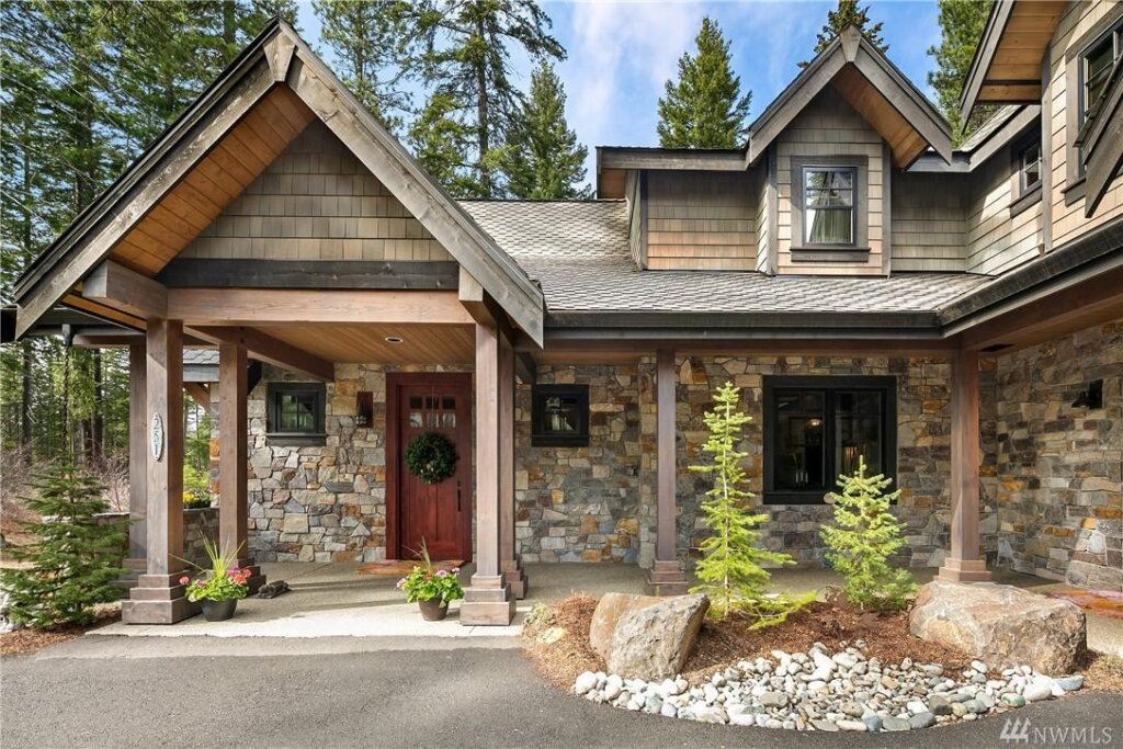 a stone house with a red front door.