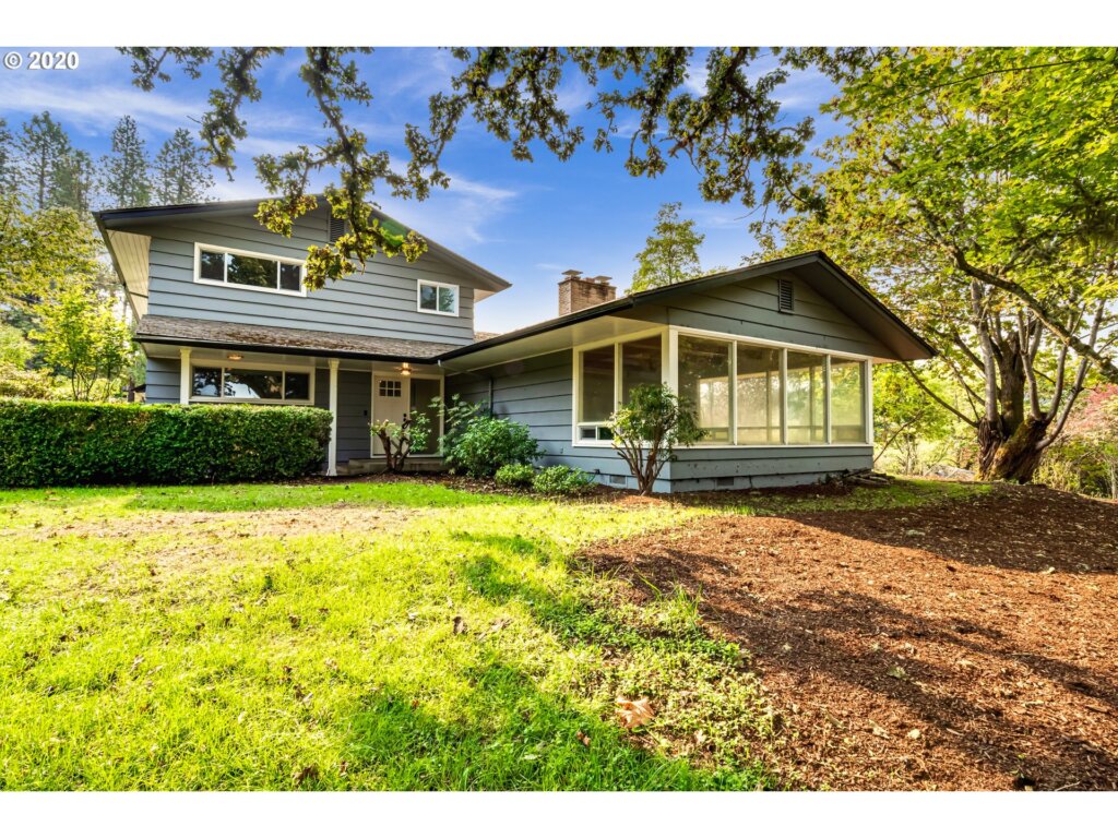 a house with a tree in front of it.