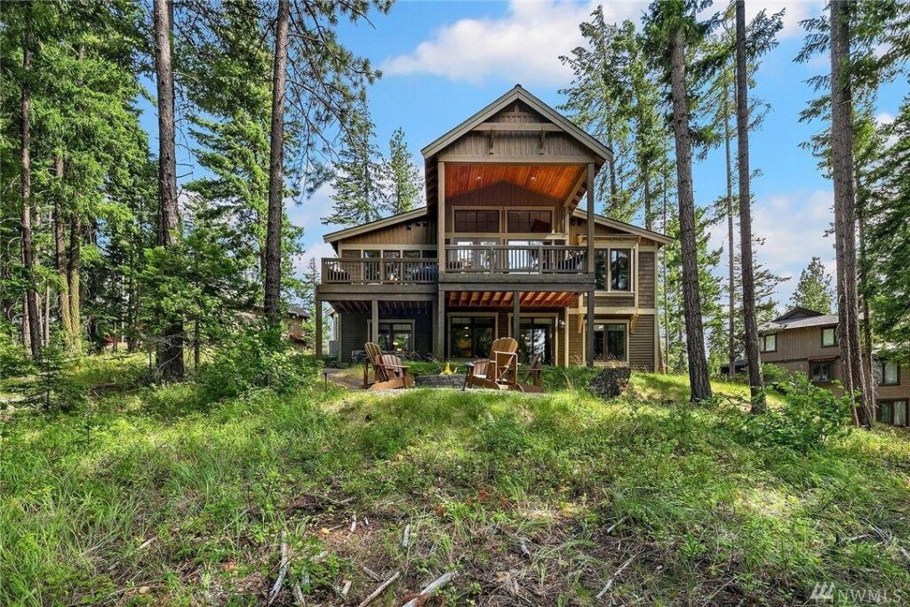 a house in the woods surrounded by trees.