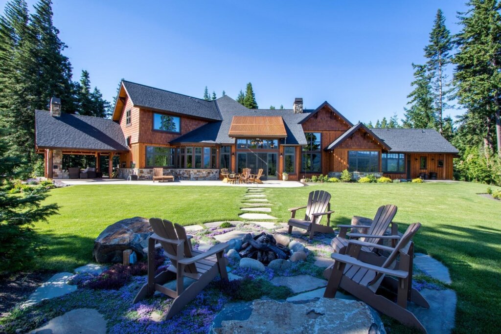 a large house with lawn chairs in front of it.