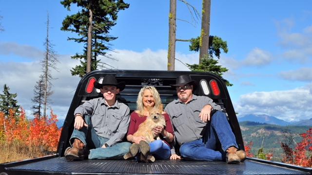 a couple of people sitting in the back of a truck.