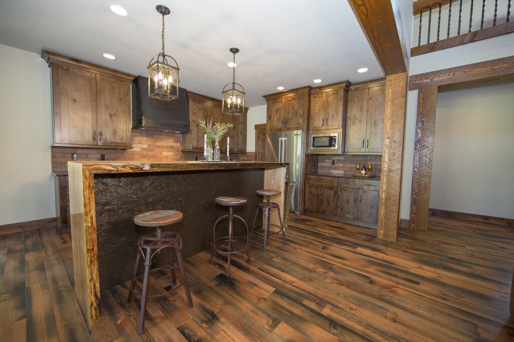 a kitchen with wooden floors and a center island.