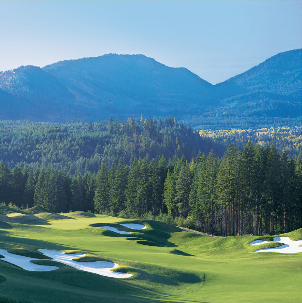 Nestled amid the rolling hills and mountains, the golf course at Suncadia features sand bunkers and evergreen trees, all under a clear blue sky. Plus, nearby Cle Elum restaurants offer delightful dining experiences after a day on the greens.