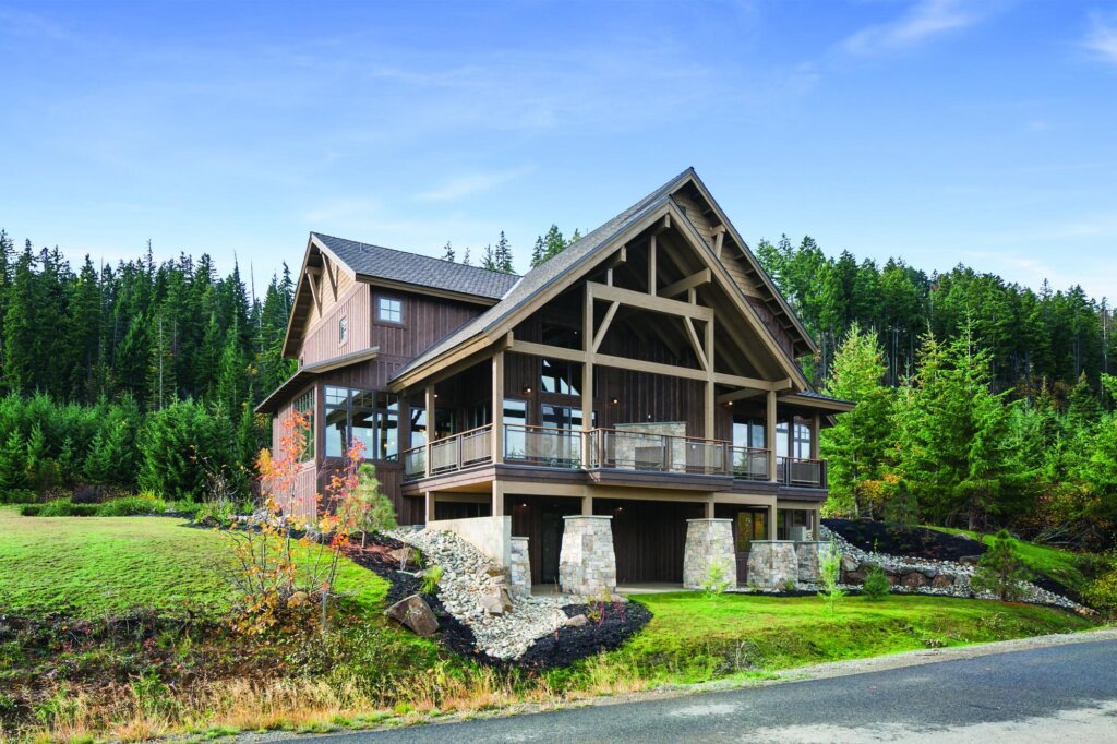 a large wooden house sitting on the side of a road.