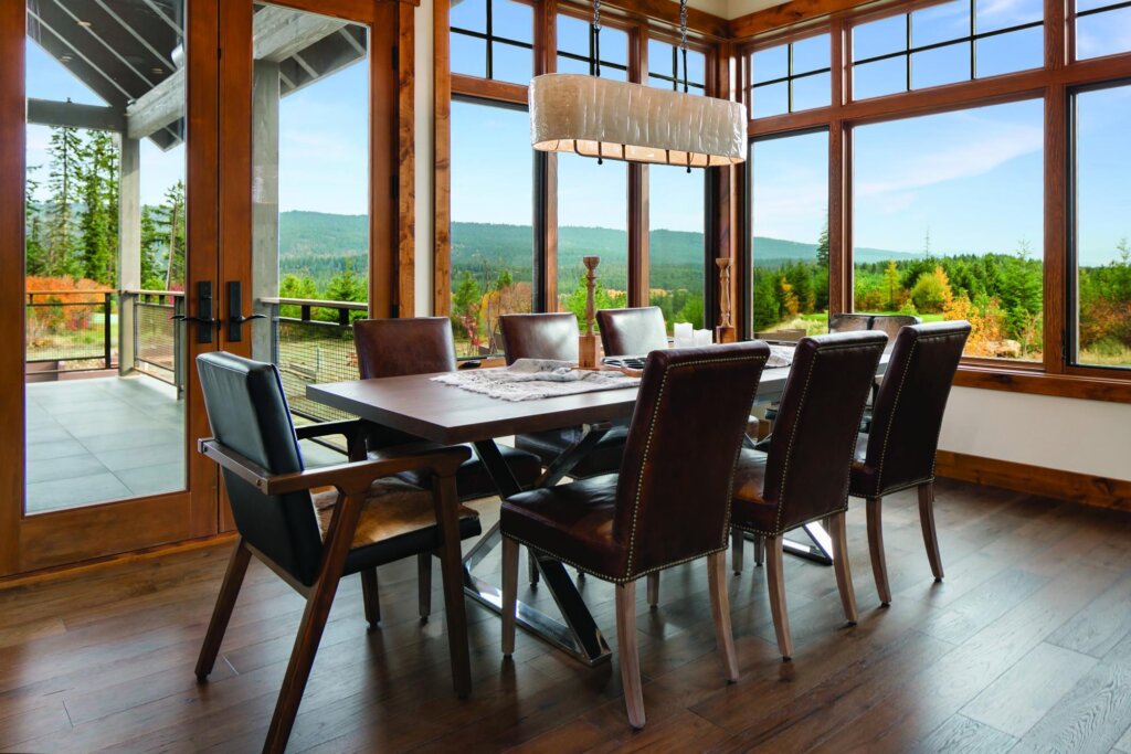 a dining room table with chairs and a chandelier.