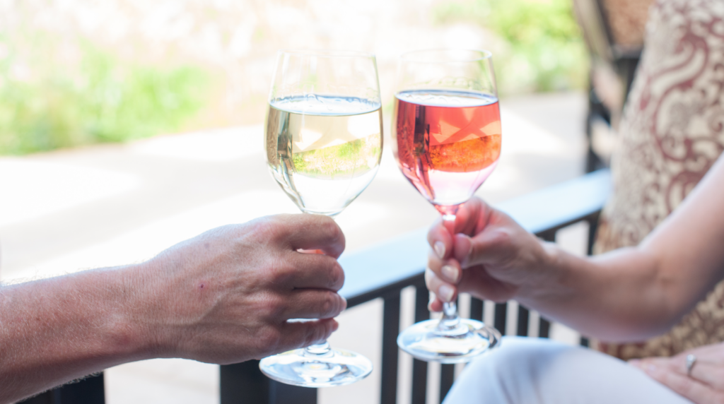 a couple of people that are holding wine glasses.