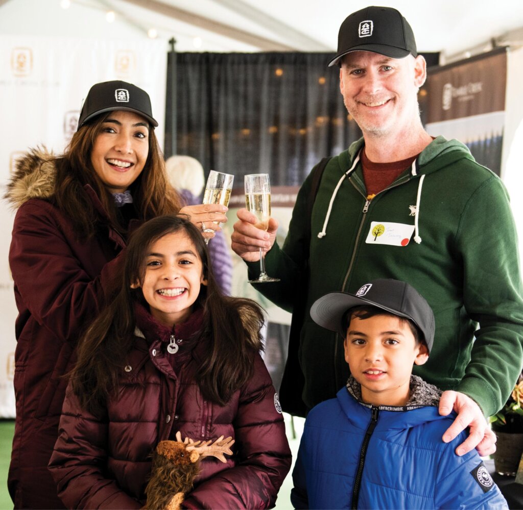 a man and two women and a boy holding wine glasses.