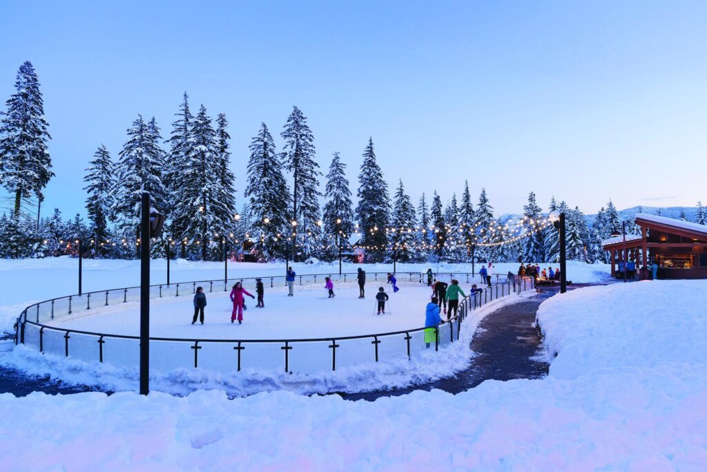 a group of people skating on an ice rink.