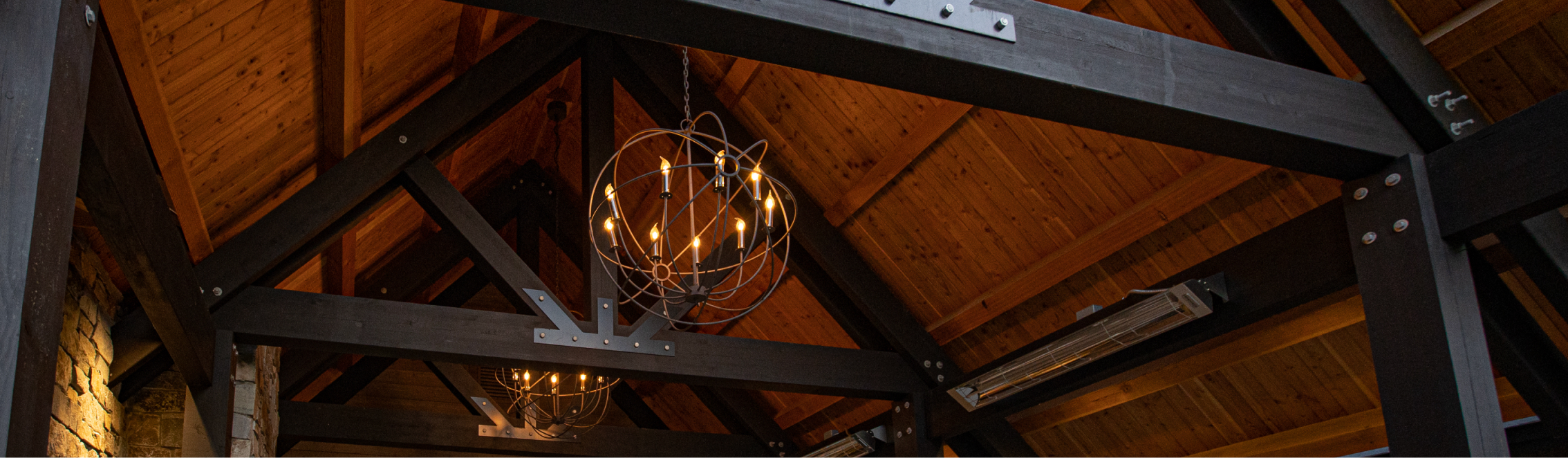 The wooden ceiling with exposed beams and two spherical metal chandeliers evokes the cozy charm of Cle Elum restaurants at Suncadia Resort.