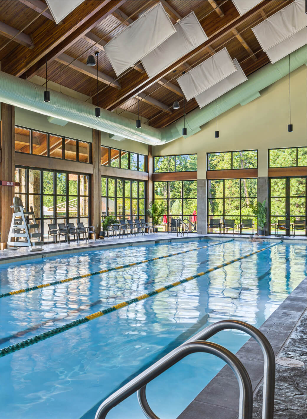 The indoor swimming pool at Suncadia Resort boasts multiple lanes, large windows, and a stunning wooden ceiling. After a refreshing swim, explore the local Cle Elum restaurants for an exquisite dining experience or delve into the enticing Suncadia real estate opportunities nearby.