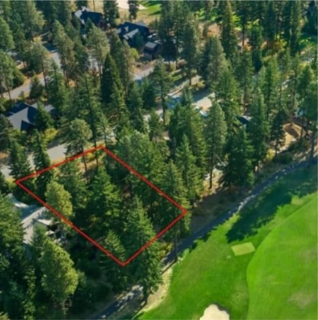 Aerial view showing a rectangular plot of land outlined in red, adjacent to a road and near a golf course, with trees and Suncadia homes nearby in the scenic surroundings of Suncadia Resort Washington.