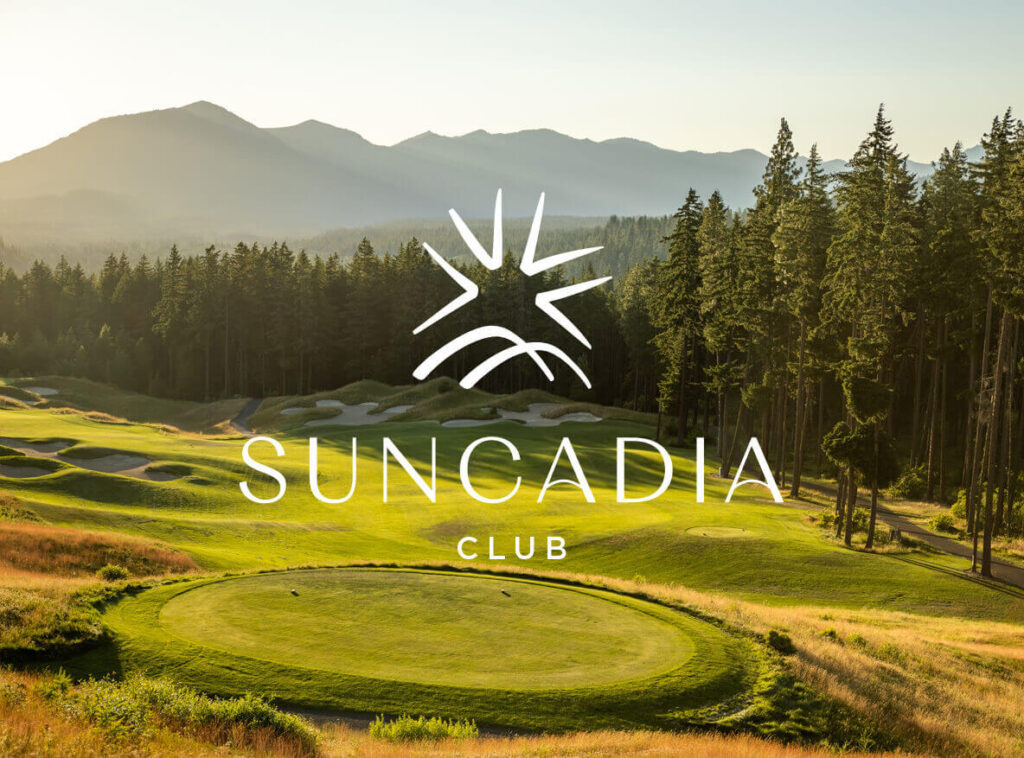 At sunrise, the Suncadia golf course unveils a stunning vista of mountains and trees, perfectly framing the iconic Suncadia Club logo in the foreground—a testament to the beauty that surrounds Suncadia real estate.