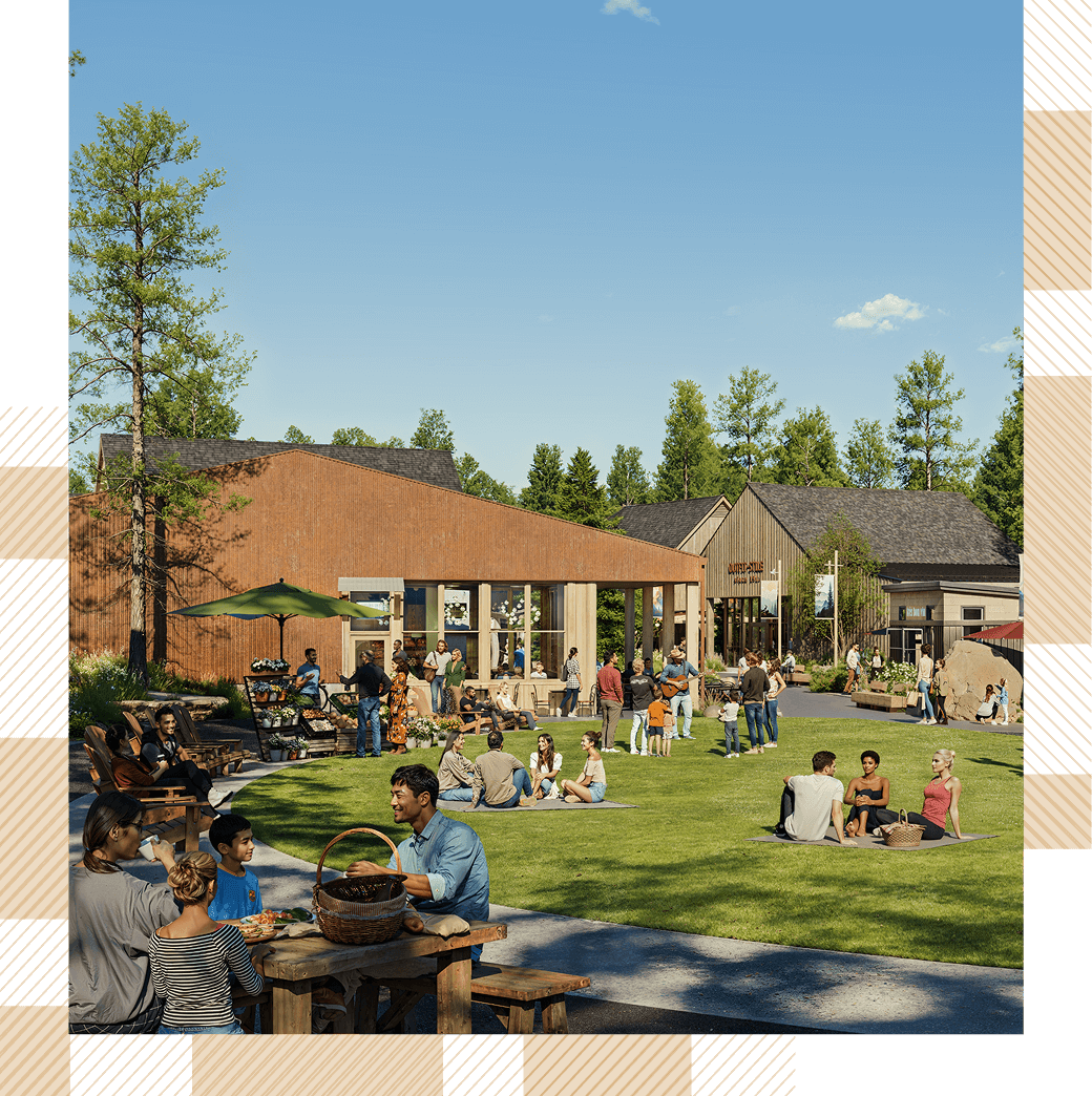 People enjoying a sunny day at an outdoor gathering with tables, a lawn, and modern buildings in the background.