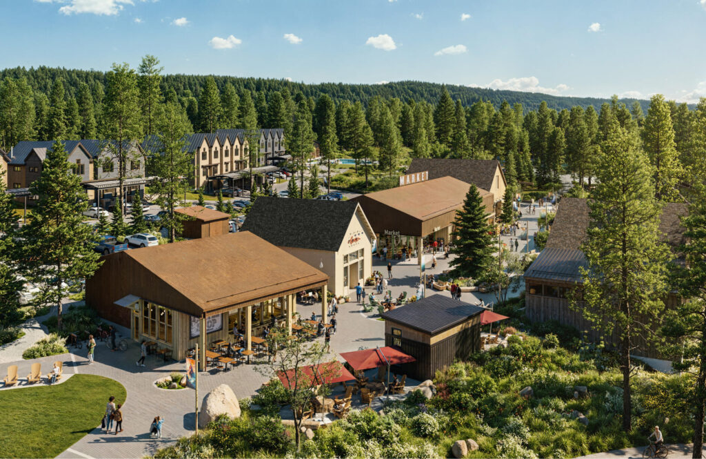 Aerial view of a small outdoor shopping plaza surrounded by trees, with people walking, outdoor seating, and parked cars visible.