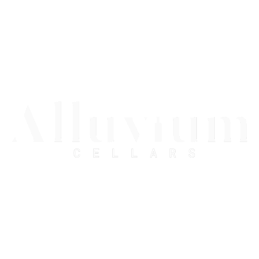 The image displays the words "Alluvium Cellars" in a bold, modern white font on a solid black background.