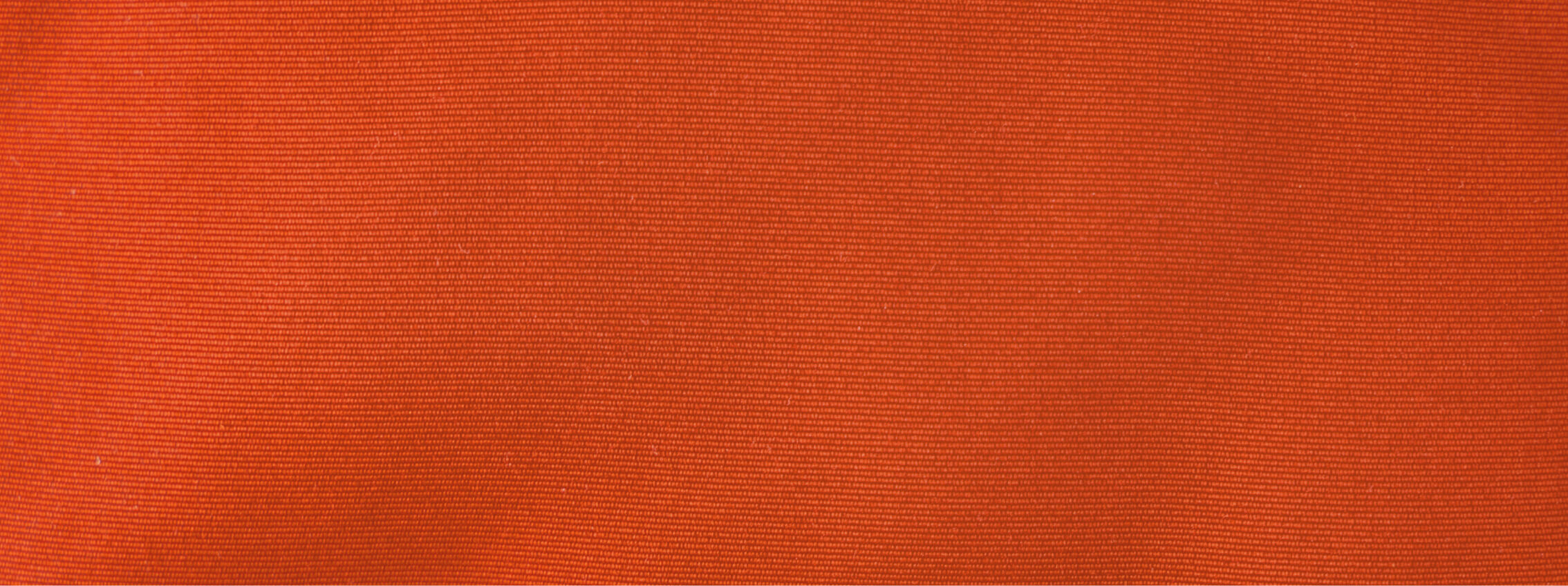 Close-up of a textured, orange fabric with fine horizontal lines running across the surface.