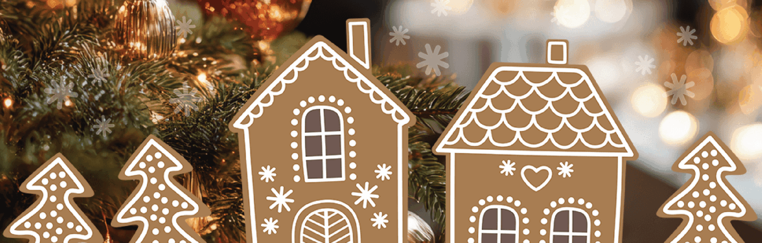 Gingerbread houses and trees are displayed in front of a decorated Christmas tree with blurred lights in the background.