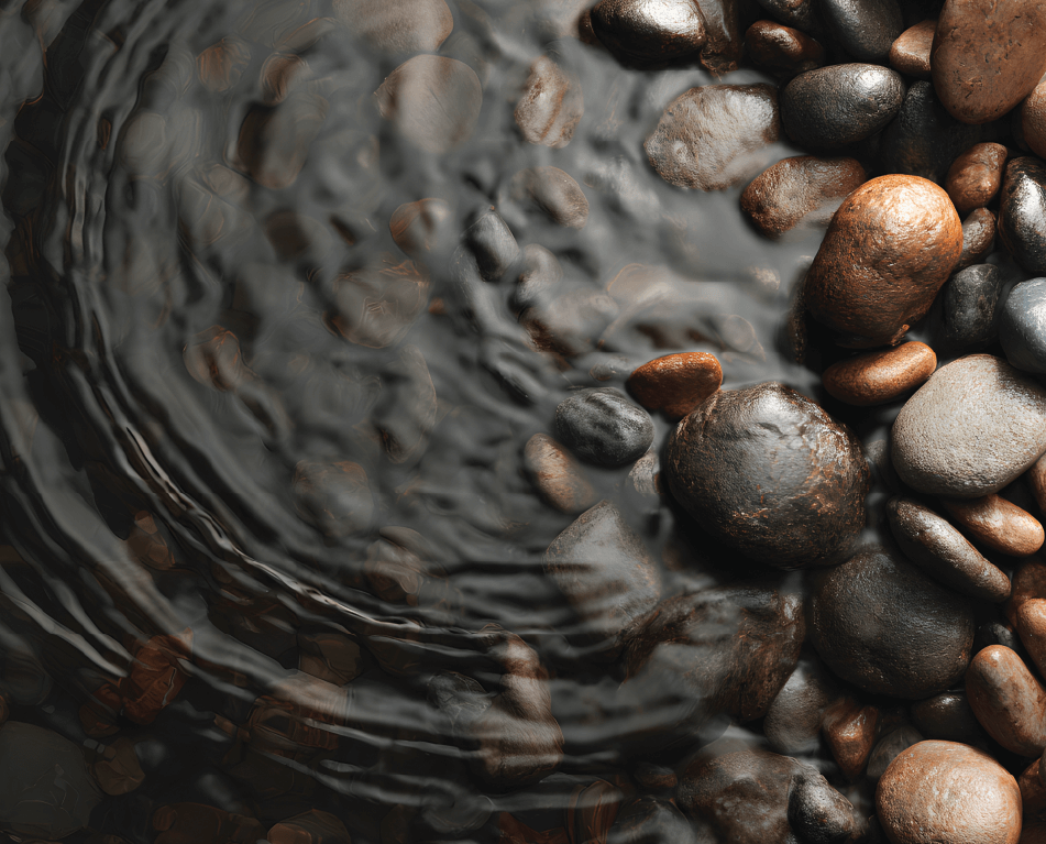 Smooth, rounded stones in varying shades of brown and gray rest beside rippling water, creating gentle concentric circles on a calm surface. The scene has a natural and tranquil atmosphere.
