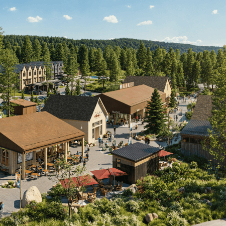An outdoor market area with several rustic buildings surrounded by pine trees; people are walking, shopping, and sitting at red umbrella-covered tables in a forested, mountainous setting.