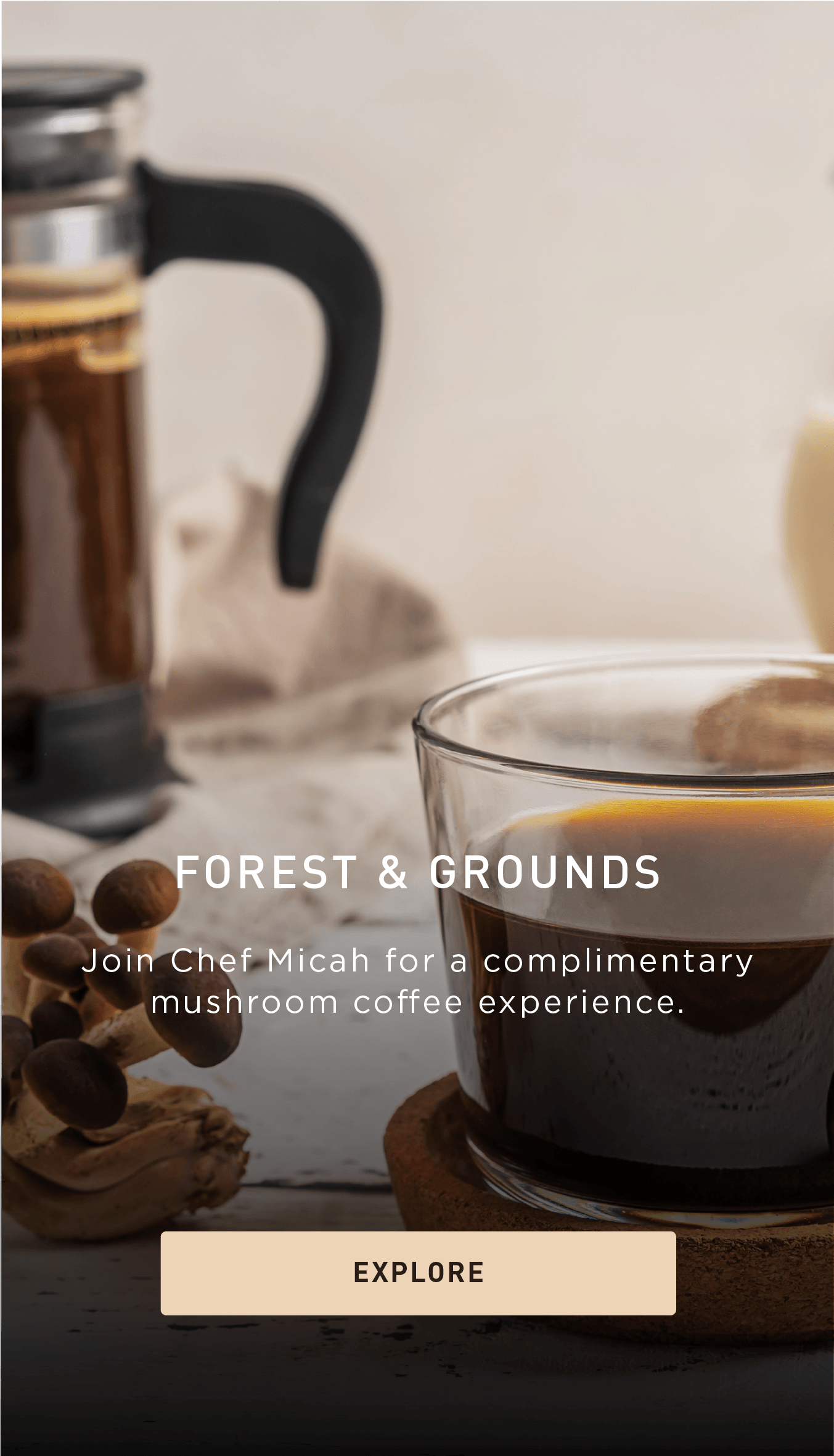 A glass mug of coffee on a coaster beside coffee beans and a French press. Text promotes a complimentary mushroom coffee experience with Chef Micah and includes an Explore button.