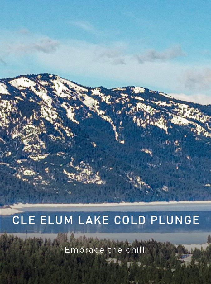 Snow-capped mountains rise above Cle Elum Lake, surrounded by pine trees under a blue sky. Text reads: Cle Elum Lake Cold Plunge. Embrace the chill. A button says Explore Connection..